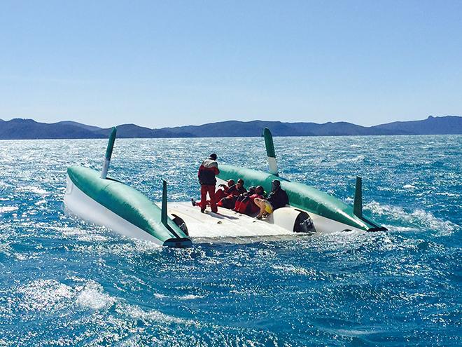 Alt All six crew of Cool Change safely huddle on the boats hullRohan Veal pic